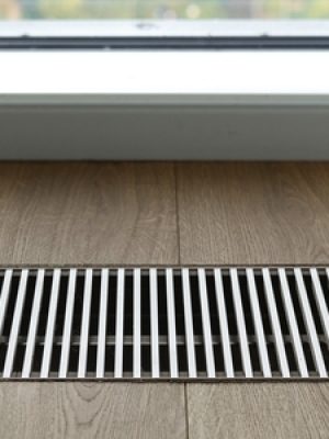 Close,Up,Of,Wooden,Floor,With,Chrome,Ventilation,Grid,Of